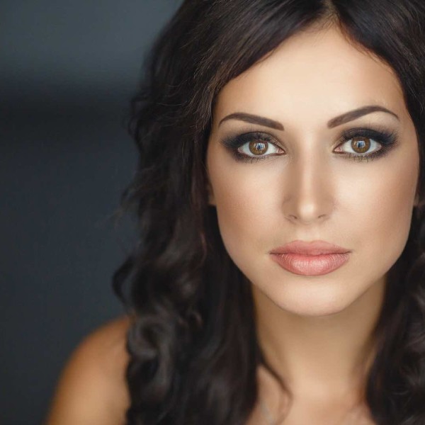 portrait of a serious lady with beautiful makeup over dark background